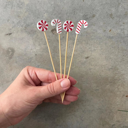 Candy cane picks garnishing a holiday cocktail