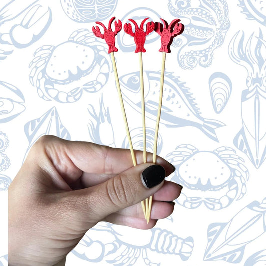 Lobster picks garnishing a coastal cocktail