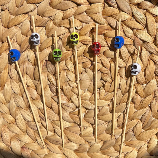 Close-up detail of colorful skull cocktail picks